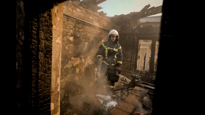 A Ukrainian firefighter stands in the ruins of a house destroyed by bombing in Kyiv, Ukraine, Wednesday, March 23, 2022 (AP) A Ukrainian firefighter stands in the ruins of a house destroyed by bombing in Kyiv, Ukraine, Wednesday, March 23, 2022 (AP)