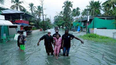 In this photograph taken on May 14, 2021, rescue personnel evacuate a resident through a flooded street in a coastal area after heavy rains under the influence of Cyclone 'Tauktae' in Kochi, India. (AFP) In this photograph taken on May 14, 2021, rescue personnel evacuate a resident through a flooded street in a coastal area after heavy rains under the influence of Cyclone 'Tauktae' in Kochi, India. (AFP)