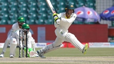 Australia's Alex Carey plays a shot while Pakistan's Mohammad Rizwan, left, and Babar Azam watch on the 2nd day of the third Test between Pakistan and Australia at the Gaddafi Stadium in Lahore, (AP) Australia's Alex Carey plays a shot while Pakistan's Mohammad Rizwan, left, and Babar Azam watch on the 2nd day of the third Test between Pakistan and Australia at the Gaddafi Stadium in Lahore, (AP)