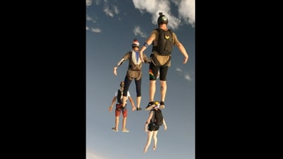 The group of skydivers making a formation mid-air in the Instagram video. (instagram/@mairis_l) The group of skydivers making a formation mid-air in the Instagram video. (instagram/@mairis_l)