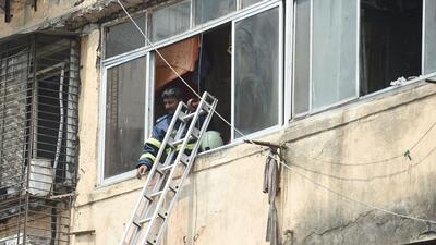 Mumbai, India - March 23, 2022: Fire brigade officials during cooling operation after blaze erupted at 12.10 pm on the third floor of four-storey Vitthal Niwas building at Jacob Circle, Saat Rasta area, Mahalaxmi, in Mumbai, India, on Wednesday, March 23, 2022. (Photo by Pratik Chorge/Hindustan Times) (Pratik Chorge/HT PHOTO) Mumbai, India - March 23, 2022: Fire brigade officials during cooling operation after blaze erupted at 12.10 pm on the third floor of four-storey Vitthal Niwas building at Jacob Circle, Saat Rasta area, Mahalaxmi, in Mumbai, India, on Wednesday, March 23, 2022. (Photo by Pratik Chorge/Hindustan Times) (Pratik Chorge/HT PHOTO)