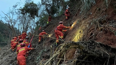 Rescuers conduct search operations at the site of a plane crash in Tengxian County in southern China's Guangxi Zhuang Autonomous Region. (AP)