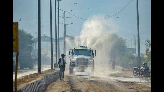 An EDMC vehicle sprinkles water over a road at Ghazipur to contain pollution, New Delhi, November, 23, 2020 (PTI) An EDMC vehicle sprinkles water over a road at Ghazipur to contain pollution, New Delhi, November, 23, 2020 (PTI)