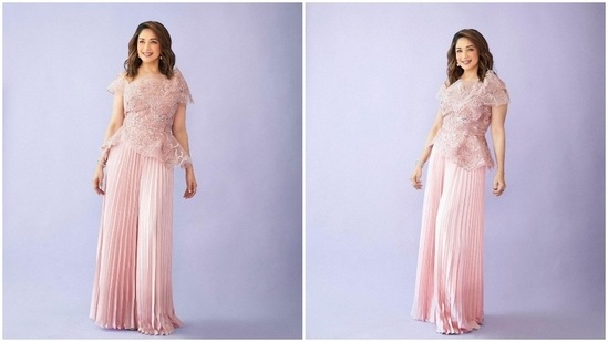 For an earlier photoshoot, Madhuri Dixit donned a pastel pink mesh top teamed with pleated pants by designer Tanieya Khanuja.(Instagram/@madhuridixitnene)