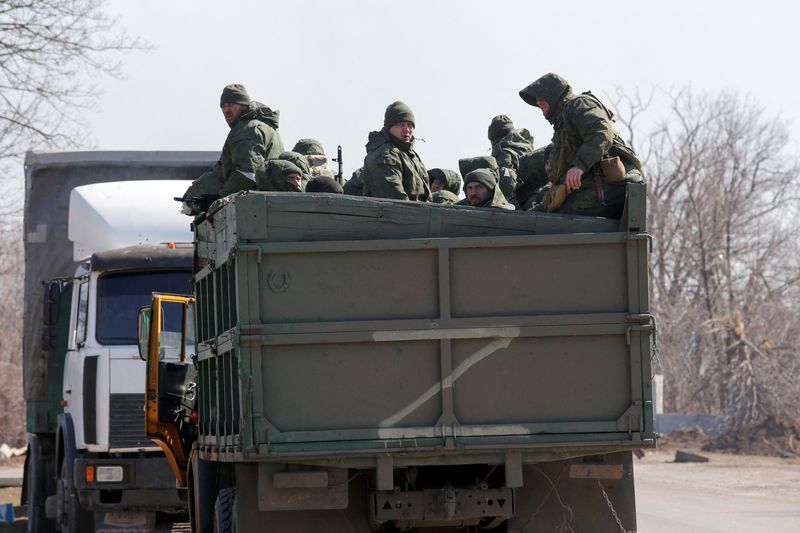 Service members of pro-Russian troops are seen in the body of a truck during Ukraine-Russia conflict on a road near the besieged southern port city of Mariupol on March 21, 2022.&nbsp; (REUTERS)