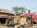 Firemen douse the fire at the incident site where several houses were allegedly set on fire leaving eight people dead, at Rampurhat, in Birbhum on Tuesday.