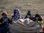 Ukrainian refugee children wait to cross over into Poland via the Medyka border crossing in Shehyni, Ukraine