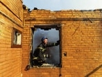 A firefighter at a residential building damaged in shelling in Kyiv on Wednesday. REUTERS