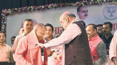Union home minister Amit Shah with UP CM-designate Yogi Adityanath at Lok Bhawan in Lucknow on Thursday. (PTI) Union home minister Amit Shah with UP CM-designate Yogi Adityanath at Lok Bhawan in Lucknow on Thursday. (PTI)