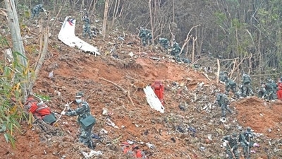 Rescuers search for the black boxes at the plane crash site (Zhou Hua/Xinhua via REUTERS) (VIA REUTERS)