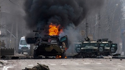 A file photo of a Russian armored personnel carrier burning amid damaged and abandoned light utility vehicles after fighting in Kharkiv, Ukraine (AP) A file photo of a Russian armored personnel carrier burning amid damaged and abandoned light utility vehicles after fighting in Kharkiv, Ukraine (AP)