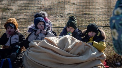 Ukrainian refugee children wait to cross over into Poland via the Medyka border crossing in Shehyni, Ukraine (Bloomberg) Ukrainian refugee children wait to cross over into Poland via the Medyka border crossing in Shehyni, Ukraine (Bloomberg)
