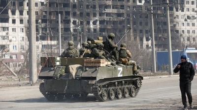 Service members of pro-Russian troops are seen atop of an armoured vehicle with a symbol "Z" painted on its side in the course of Ukraine-Russia conflict in the besieged southern port city of Mariupol. (REUTERS)