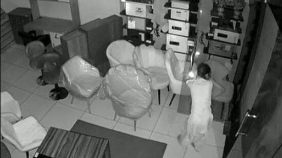 CCTV camera installed inside the store shows a member of the women’s gang stealing cash from the store in Ludhiana. (HT File)