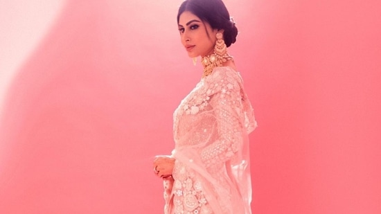 Pulling back her silky tresses into a mid-parted low bun, Mouni accessorised her look with a pair of gold earrings, a statement layered choker and finger rings all from Tyaani Fine Jewellery. (Instagram/imouniroy )
