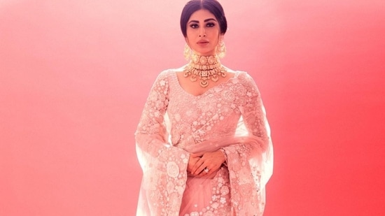 Taking to her social media handle, Mouni shared a slew of pictures where she was seen posing elegantly or striking classical dance poses while donning a sheer full sleeves blouse that sported floral metallic work all over. (Instagram/imouniroy )