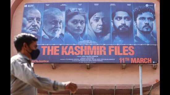 A man walks past a poster "The Kashmir Files", Mumbai, March 16, 2022 (REUTERS)