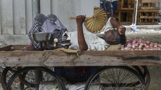 A vegetable seller takes rest on cart as the Chennai city. PTI A vegetable seller takes rest on cart as the Chennai city. PTI