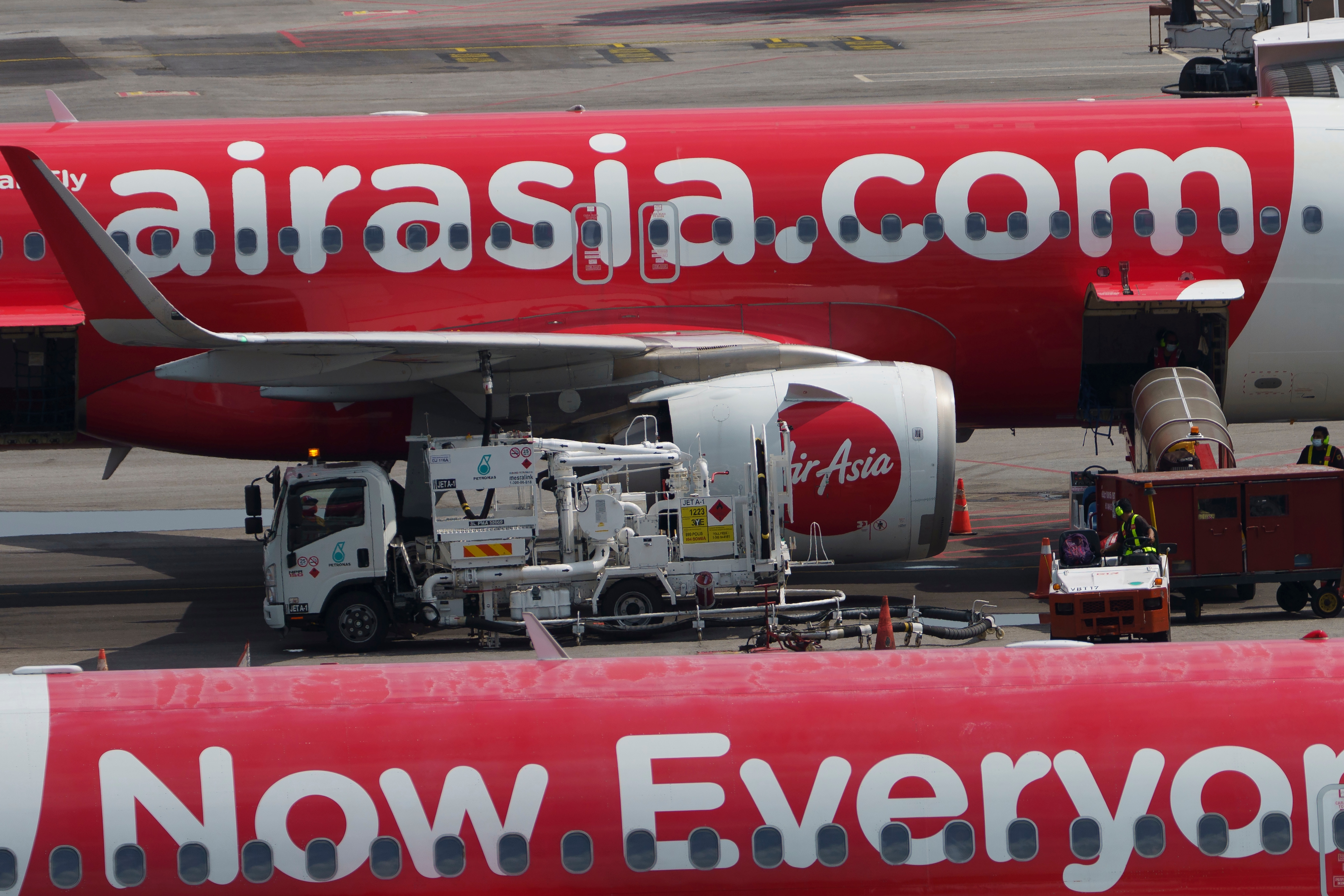 An AirAsia India flight rolled back 100 feet at the Kempegowda International Airport after landing safely on Tuesday. (AP Photo/Vincent Thian) (AP) An AirAsia India flight rolled back 100 feet at the Kempegowda International Airport after landing safely on Tuesday. (AP Photo/Vincent Thian) (AP)