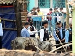 The CBI's Central Forensic Science Laboratory (CFSL) experts collect samples from the houses at Bogtui village, in Birbhum on Friday.