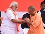 Prime Minister Narendra Modi shares the stage at Lucknow's Ekana Stadium with Yogi Adityanath, who sworn-in as the chief minister of Uttar Pradesh for a record second term on Friday, March 25, 2022. (Photo by Deepak Gupta/HT)