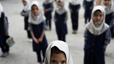 Afghan girls look on at a school in Kabul, Afghanistan, September 18, 2021. (REUTERS/ Picture provided by a third party: TPX IMAGES OF THE DAY)