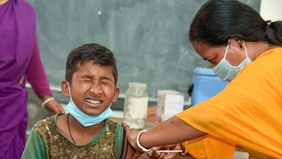A healthcare worker administers a dose of the Covid-19 preventive vaccine to a student in the age group of 12-14 years, at a government school. (PTI)