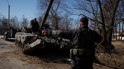 A Ukrainian soldier directs a Russian tank that Ukrainians captured after fighting with Russian troops, as Russia's attack on Ukraine continues, outside Brovary, near Kyiv, Ukraine. (REUTERS file photo)