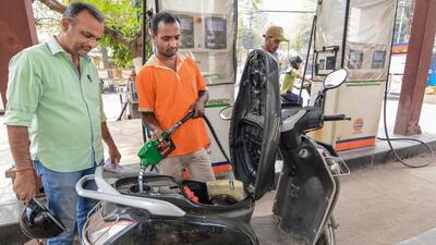 A petrol pump attendant attends to a customer in Guwahati on Tuesday. (PTI Photo) A petrol pump attendant attends to a customer in Guwahati on Tuesday. (PTI Photo)