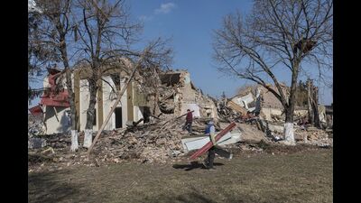 Locals clean up debris from the cultural centre destroyed in shelling earlier this month, as Russia's invasion of Ukraine continues, in the village of Byshiv outside Kyiv, Ukraine, March 24, 2022 (REUTERS) Locals clean up debris from the cultural centre destroyed in shelling earlier this month, as Russia's invasion of Ukraine continues, in the village of Byshiv outside Kyiv, Ukraine, March 24, 2022 (REUTERS)