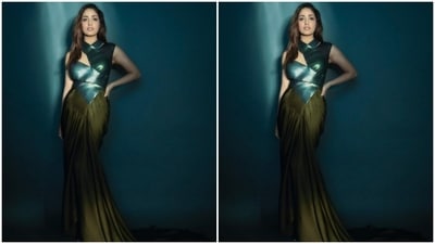 Yami’s gown came with emerald green metallic wrap-around details above the waist. Below the waist, the gown cascaded to a moss green satin skirt with flowy details and pleats. (Instagram/@yamigautam)