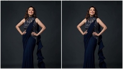 Madhuri played muse to fashion designer Gaurav Gupta and picked the midnight swirl saree to step out for a party. (Instagram/@gauravguptaofficial)