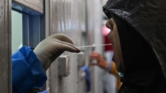 A man is tested as a measure against the Covid-19 coronavirus near the Shanghai Jin'an Central Hospital in Shanghai.(AFP)