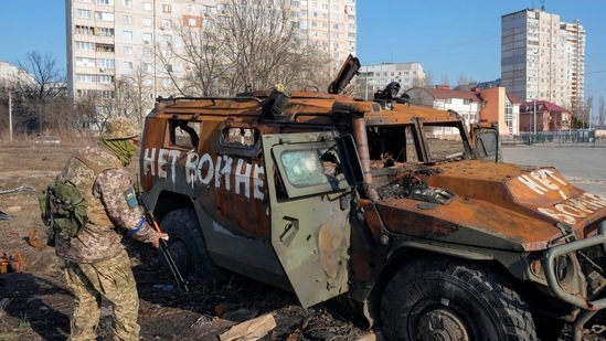 A Ukrainian soldier inspects a destroyed Russian APC after recent battle in Kharkiv, Ukraine.&nbsp;(AP)