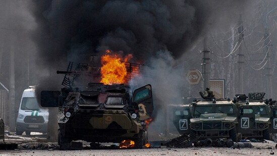 A file photo of a Russian armored personnel carrier burning amid damaged and abandoned light utility vehicles after fighting in Kharkiv, Ukraine(AP)