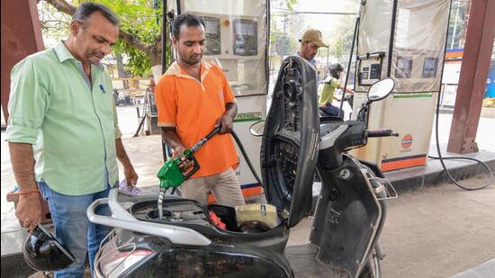 A petrol pump attendant attends to a customer in Guwahati on Tuesday. (PTI Photo)