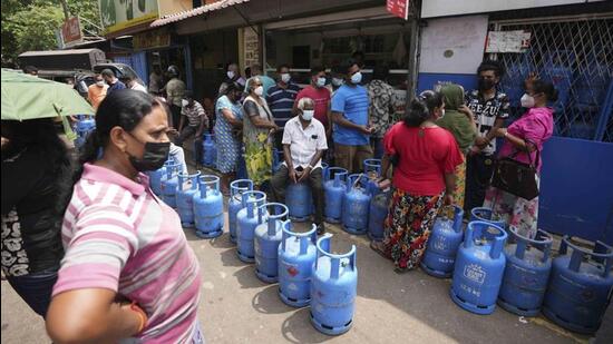 Sri Lankans wait to buy cooking gas at a vendor in Colombo, Sri Lanka, on Friday. (AP)