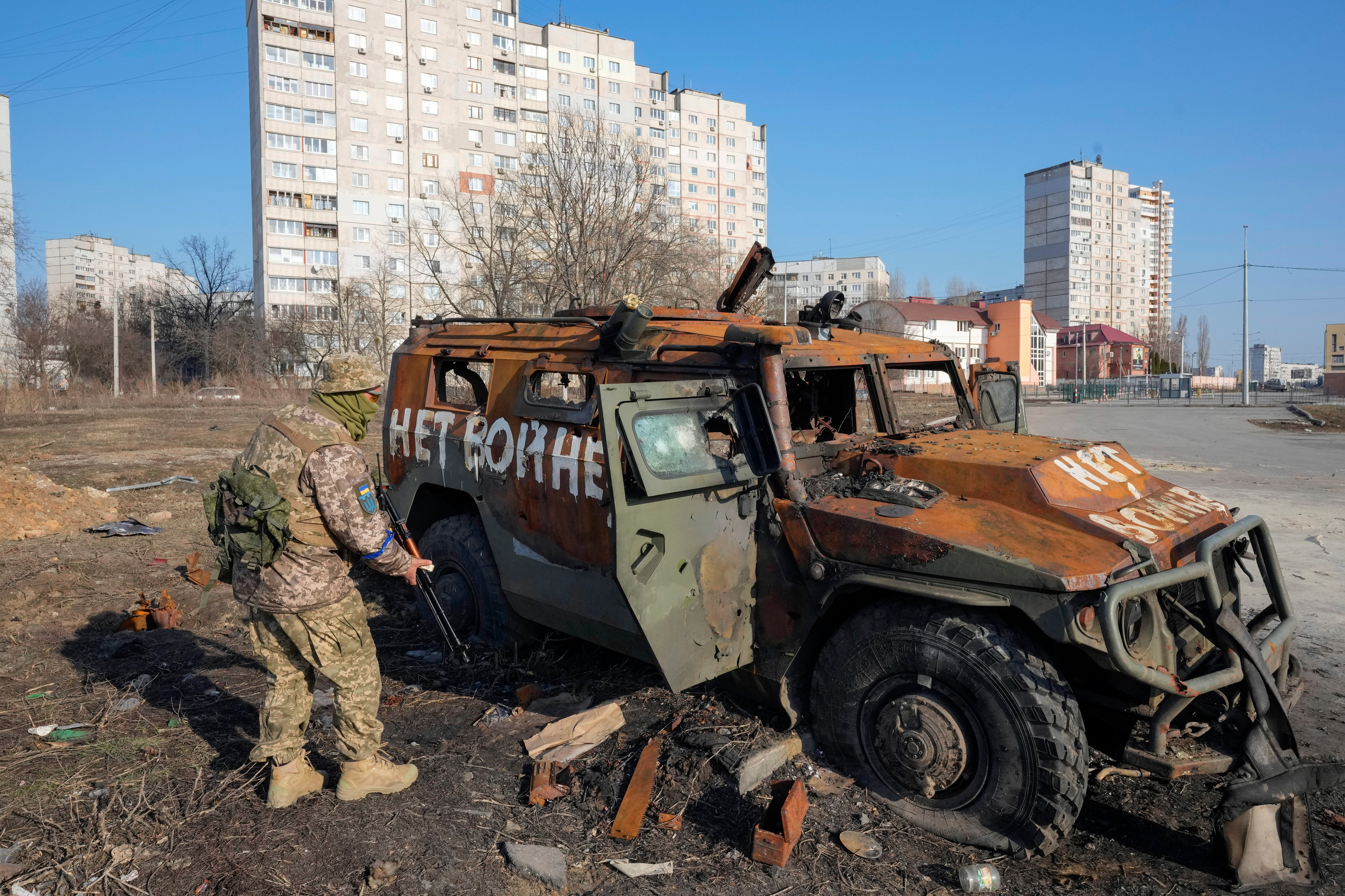 A Ukrainian soldier inspects a destroyed Russian APC after recent battle in Kharkiv, Ukraine. (AP) A Ukrainian soldier inspects a destroyed Russian APC after recent battle in Kharkiv, Ukraine. (AP)