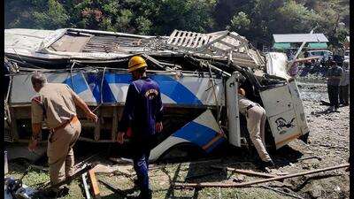 The bus that was on its way to Chail from Kandaghat skidded off the road and fell into a gorge at Sadhupul in Solan district on Saturday. (HT Photo)