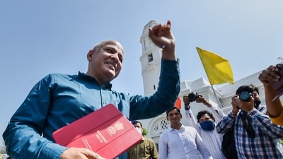 Delhi Dy CM and Finance Minister Manish Sisodia arrives to present the annual budget 2022-23 in Delhi Assembly Saturday. (PTI)