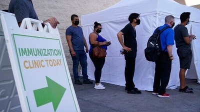People wait in line for COVID-19 vaccinations in Las Vegas. (AP Photo/John Locher, File) People wait in line for COVID-19 vaccinations in Las Vegas. (AP Photo/John Locher, File)
