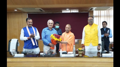 Chief Secretary Durga Shankar Mishra presenting a bouquet of flowers to chief minister Yogi Adityanath on his first day after taking the oath of office, with deputy chief ministers Brijesh Pathak, right, and Keshav Prasad Maurya, left, standing beside him in Lucknow on Saturday. (Agency) Chief Secretary Durga Shankar Mishra presenting a bouquet of flowers to chief minister Yogi Adityanath on his first day after taking the oath of office, with deputy chief ministers Brijesh Pathak, right, and Keshav Prasad Maurya, left, standing beside him in Lucknow on Saturday. (Agency)