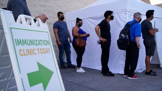 People wait in line for COVID-19 vaccinations in Las Vegas. (AP Photo/John Locher, File)