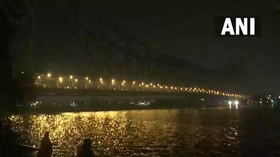 The iconic Howrah Bridge, built during the British regime, slowly turns dark to mark Earth Hour on Saturday, March 26, 2022. (ANI Photo)