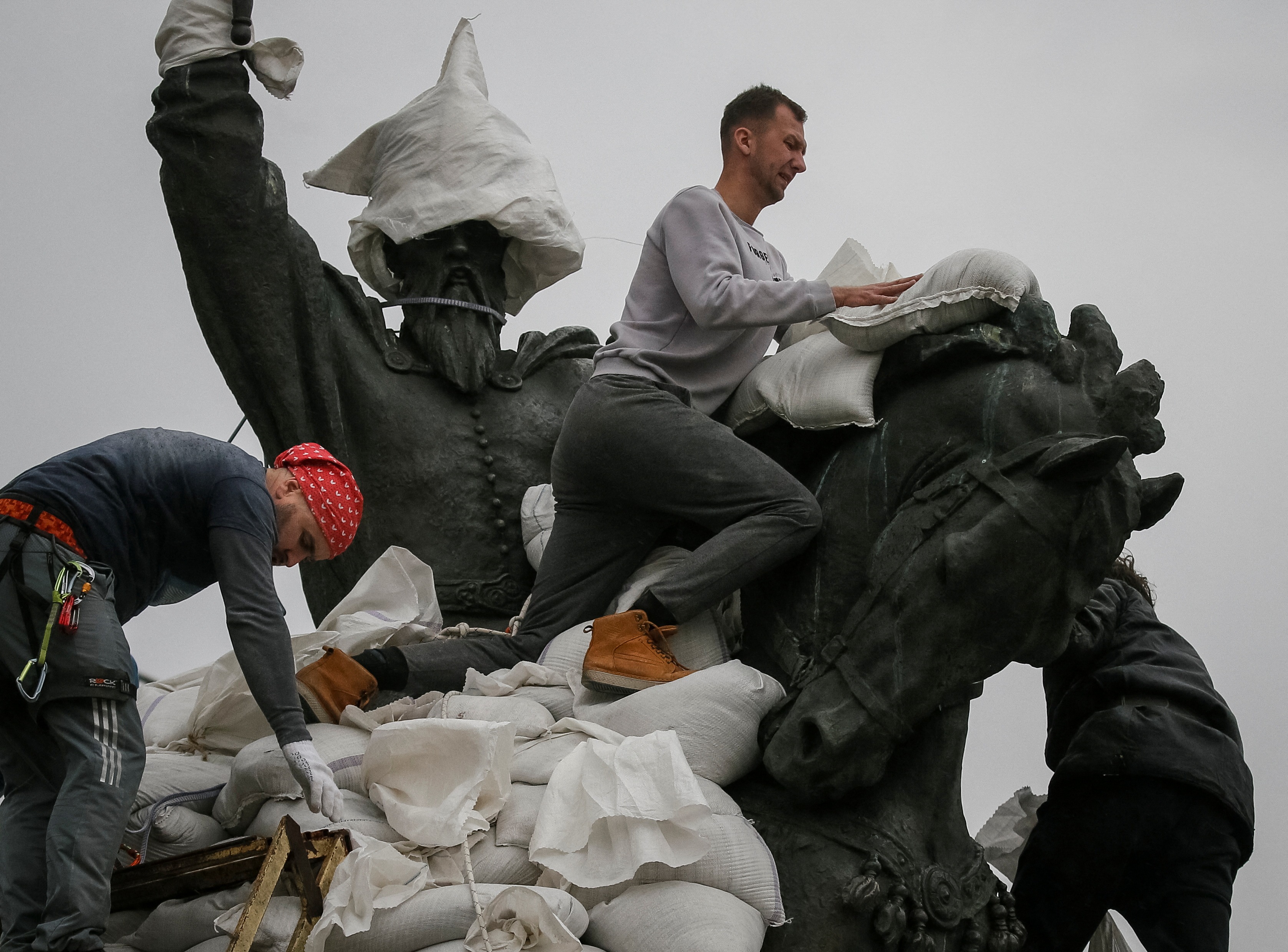 Volunteers cover a monument of the Petro Sahaidachny of sand bags for protection as Russia's invasion of Ukraine continues, in central Kyiv. (REUTERS)