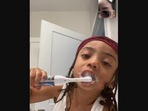 The little boy brushes his teeth in this photo posted on Twitter, with his mom on video call. (twitter/@xo_melss) The little boy brushes his teeth in this photo posted on Twitter, with his mom on video call. (twitter/@xo_melss)