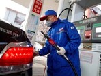 A pump attendant refuels a car at a Sinopec gas station in Beijing, China,(REUTERS)
