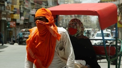 A rickshaw puller covers his face from the heatwave as temperature touches 44 degrees, in New Delhi. (ANI Photo)