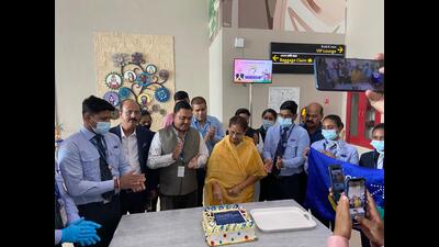 Phulpur MP Keshari Devi Patel cutting the cake at Prayagraj airport on Sunday. (HT PHOTO)