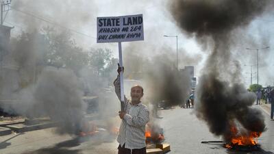 People burn tyres and block the Narwal Jammu and Kashmir National Highway in protest after the revenue department conducted an anti-encroachment drive, in Jammu, onSunday. (PTI) People burn tyres and block the Narwal Jammu and Kashmir National Highway in protest after the revenue department conducted an anti-encroachment drive, in Jammu, onSunday. (PTI)
